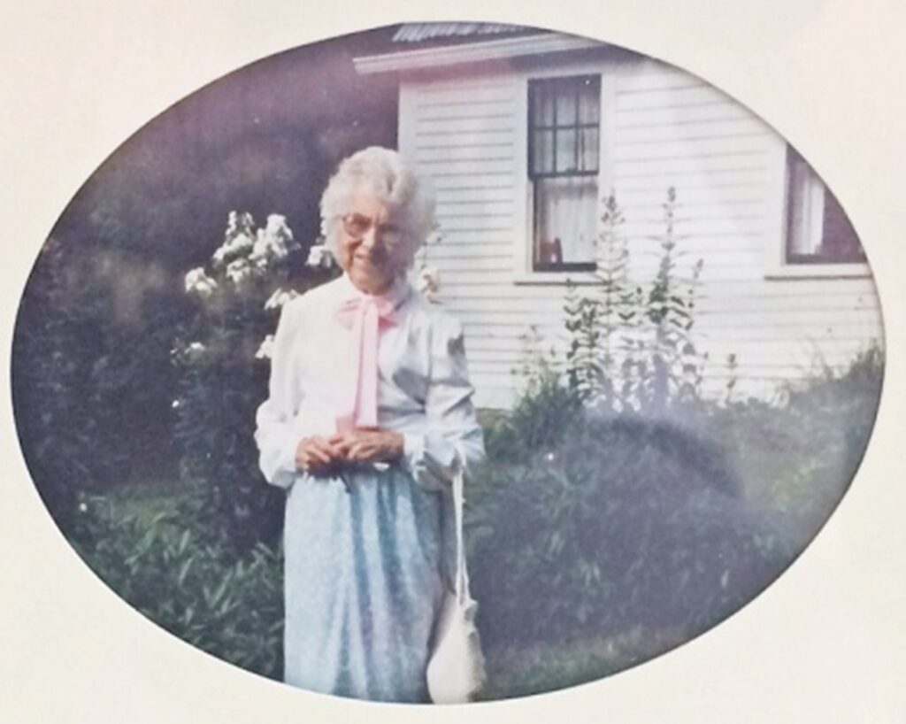 Geraldine D. Smith stands in front of her family's farmhouse in Ossipee, New Hampshire in an undated photo